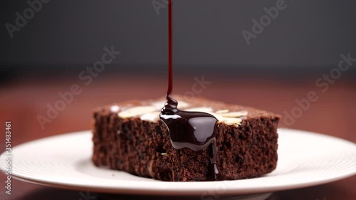 Chocolate pouring on cake in 4K Resolution. Topping chocolate on homemade brownie dessert
