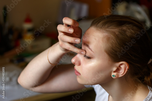 Portrait of a girl doing make up view from above