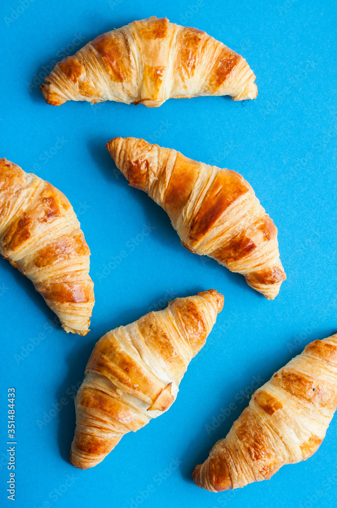 Group of croissants on a blue background.