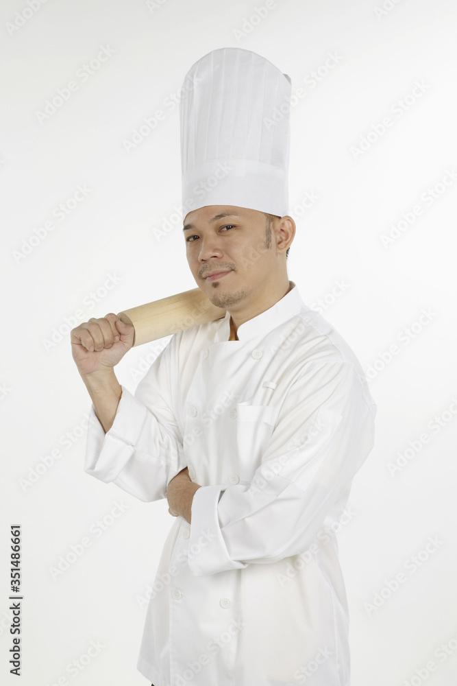 Asian chef holding a rolling pin Asian chef holding a rolling pin