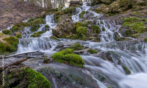 A stream of water flowing over rocks and creating a waterfall effect. © ANDA