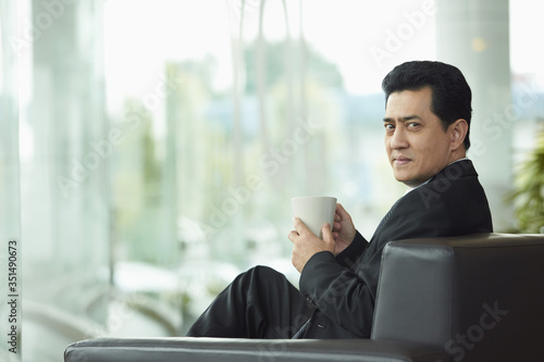 Businessman having a coffee break © ImageHit