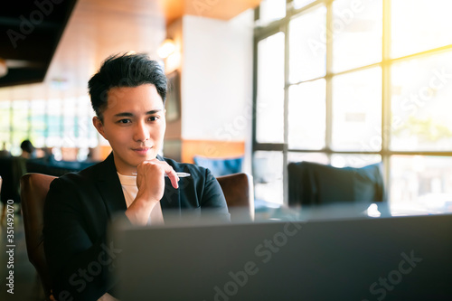 young Business man  Working On Laptop In Coffee Shop