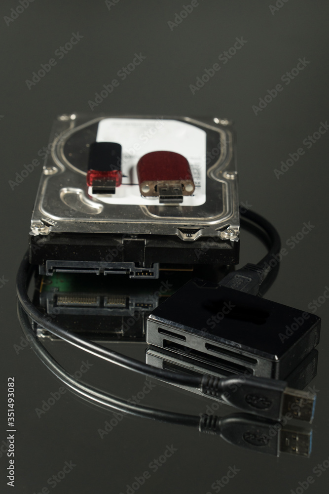 Universal card reader and hard drive isolated on black background Universal card reader and hard drive isolated on black background