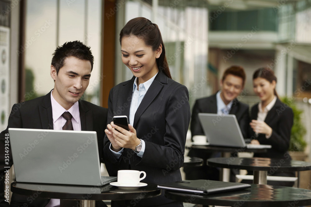Businessman and businesswoman having discussion Businessman and businesswoman having discussion