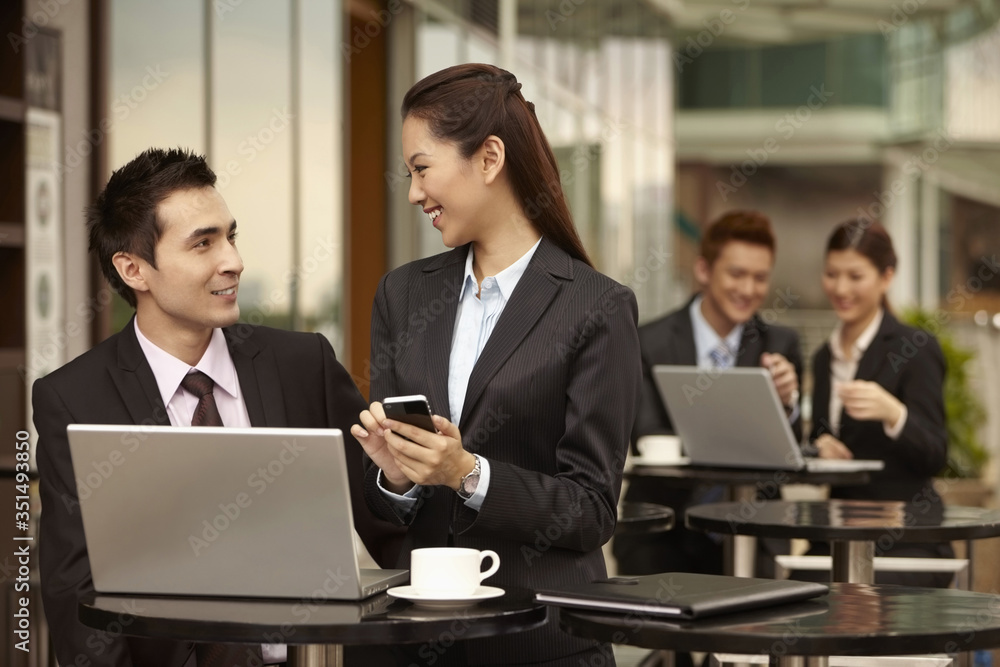Businessman and businesswoman having discussion Businessman and businesswoman having discussion