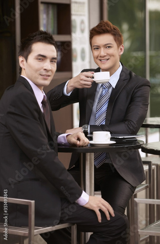 Businessmen having coffee at outdoor cafe