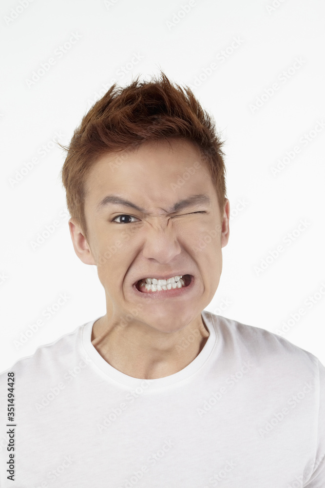 Man making face and clenching teeth Man making face and clenching teeth