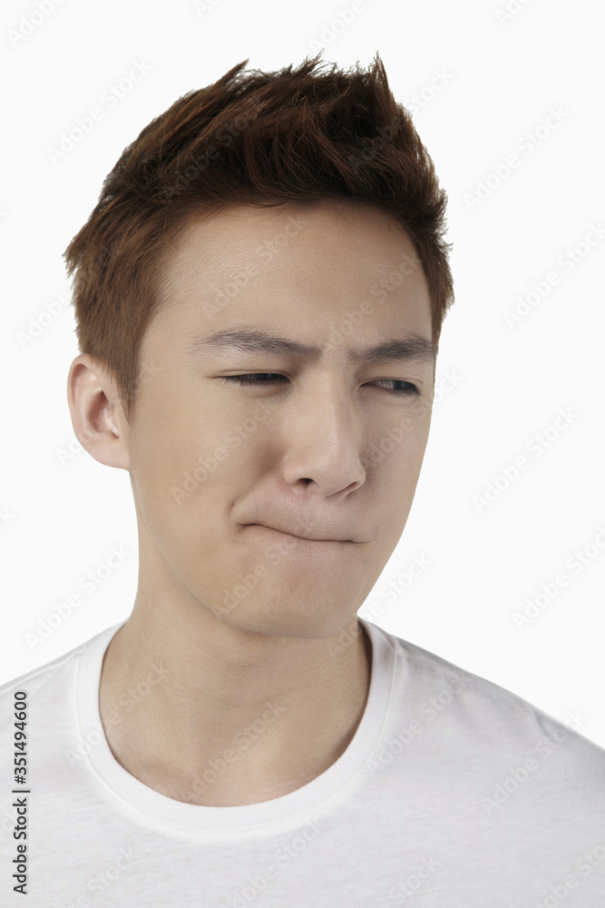 Man looking confused and grimacing Man looking confused and grimacing