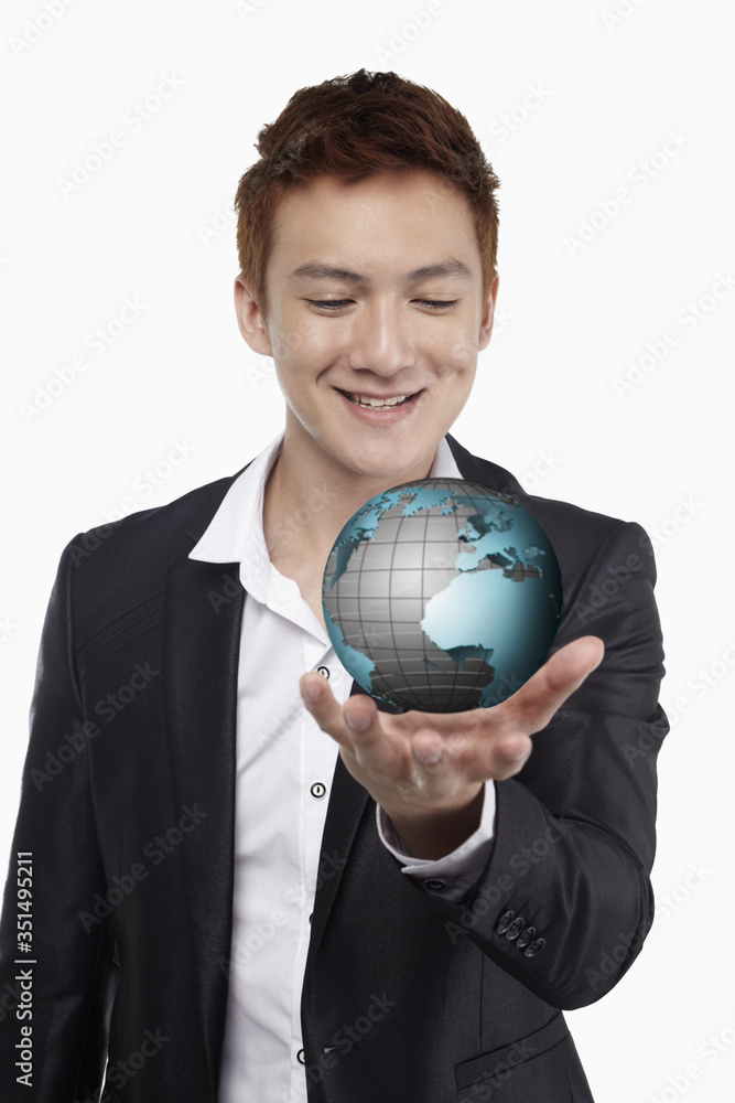 Businessman smiling and holding a globe Businessman smiling and holding a globe