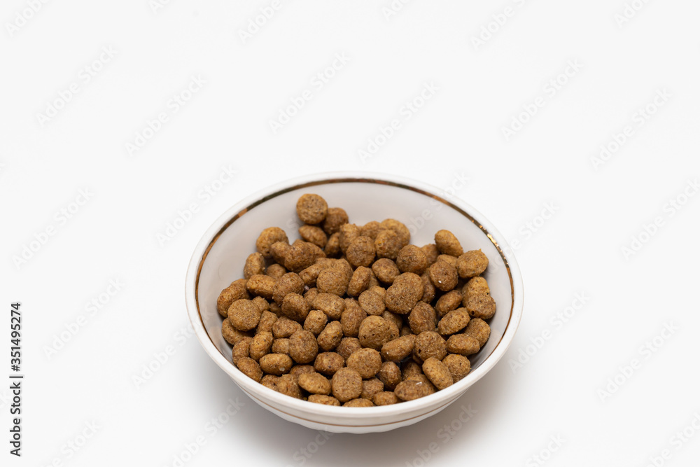 Balls of cat food in a beautiful bowl on a white background Balls of cat food in a beautiful bowl on a white background
