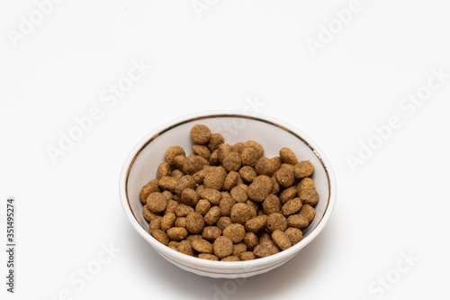 Fototapeta Naklejka Na Ścianę i Meble -  Balls of cat food in a beautiful bowl on a white background