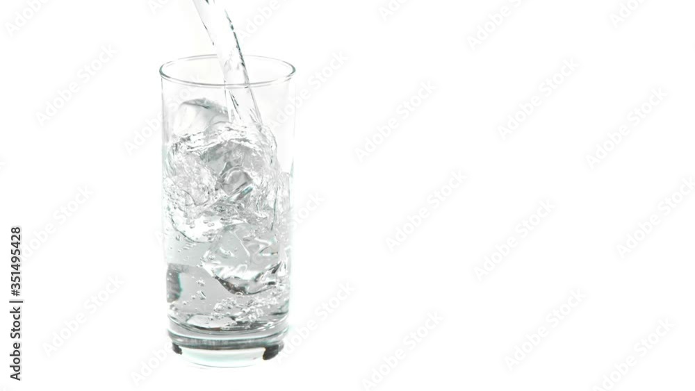 Super Slow Motion Shot of Pouring Fresh Water into Glass with Ice Cubes at 1000fps, Isolated on White Background. Super Slow Motion Shot of Pouring Fresh Water into Glass with Ice Cubes at 1000fps, Isolated on White Background.