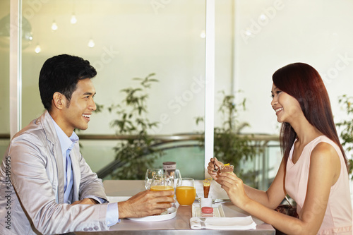 Man and woman enjoying their dessert