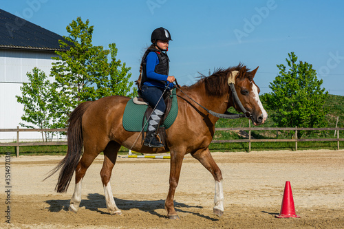 Young girl on a horse in training as an equastrian