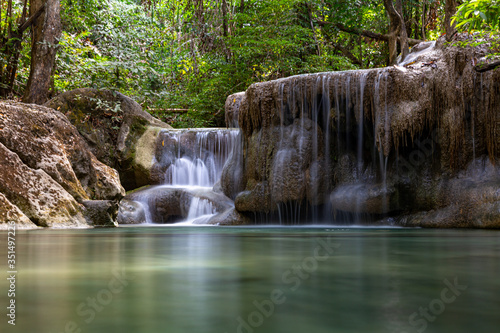 Beautiful waterfall with still emerald green water in Erawan National Parik in Kanchanaburi