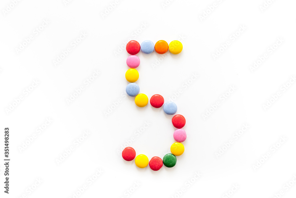 Number 5 - five - lined with sweets on isolated top-down Number 5 - five - lined with sweets on isolated top-down
