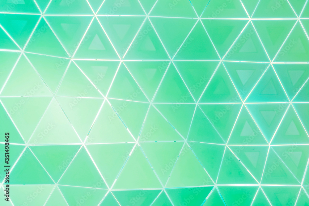 Fototapeta premium Green and white triangle patterned background vector