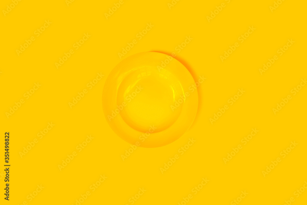 Fototapeta Yellow plate on a yellow background.
