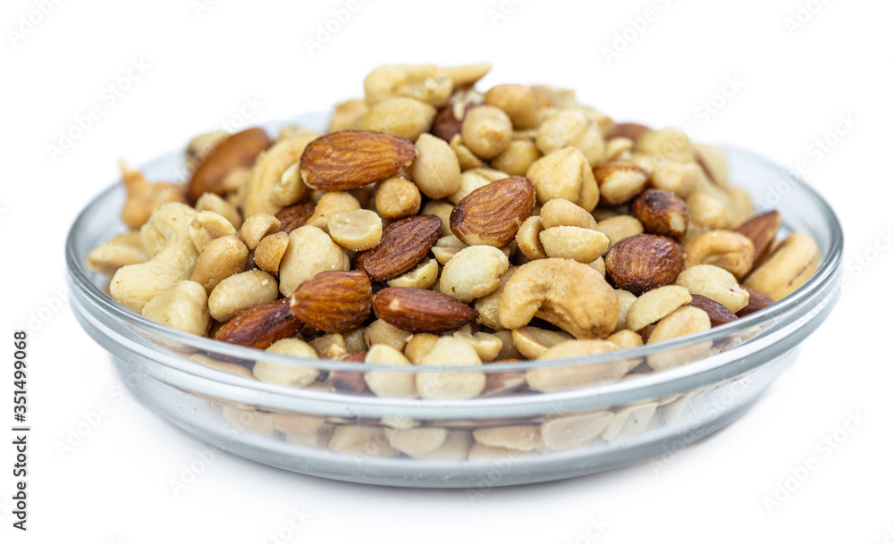 Portion of roasted nuts isolated on white (close up; selective focus) Portion of roasted nuts isolated on white (close up; selective focus)