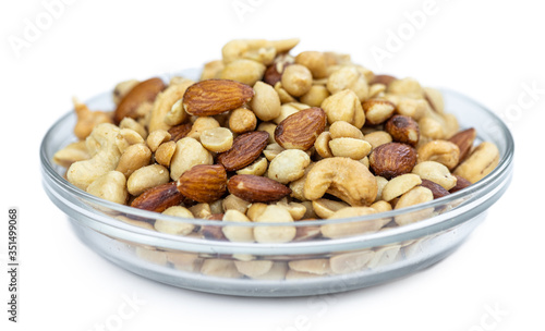 Portion of roasted nuts isolated on white (close up; selective focus)