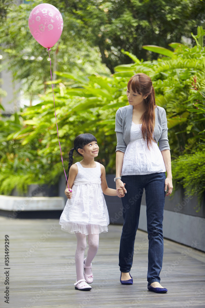 Mother and daughter walking hand in hand Mother and daughter walking hand in hand