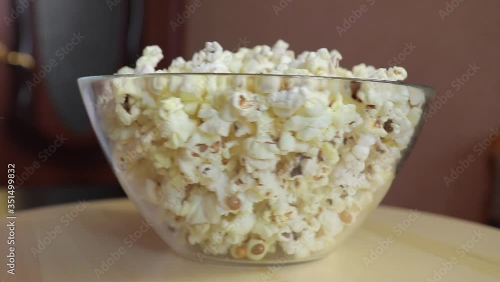 popcorn in a plate in a spinning wooden tray, fast motion popcorn in a plate in a spinning wooden tray, fast motion