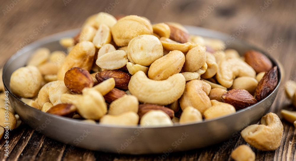 Portion of roasted nuts (close up; selective focus) Portion of roasted nuts (close up; selective focus)