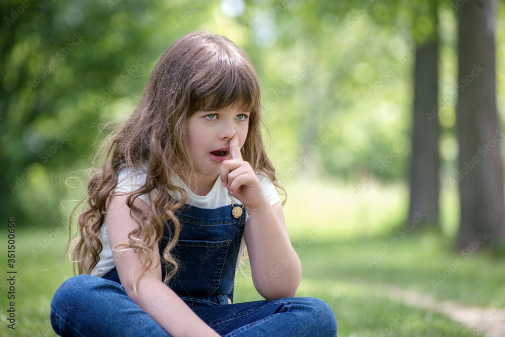Little girl scratching nose for reflection, stress, cold or allergies Little girl scratching nose for reflection, stress, cold or allergies