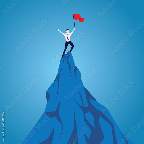Businessman celebrating achievement, standing on top of mountain with flag in hand.Purpose concept. Aspirational people. Successful mission achievement