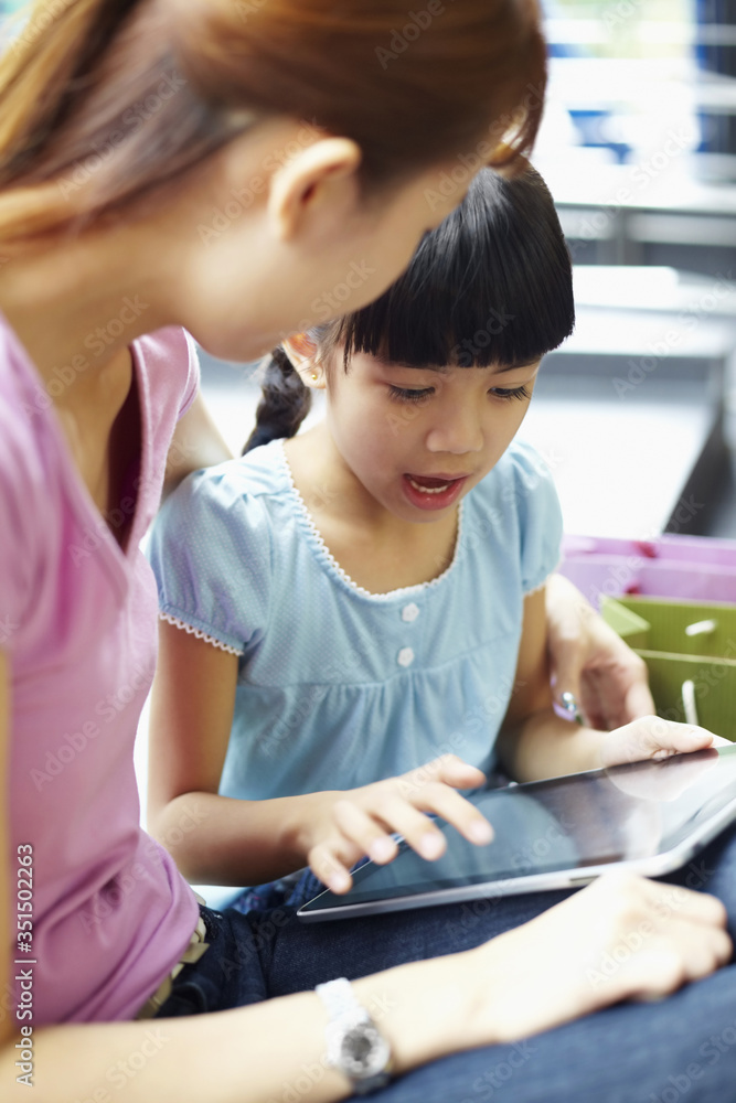 Mother and daughter using digital tablet Mother and daughter using digital tablet