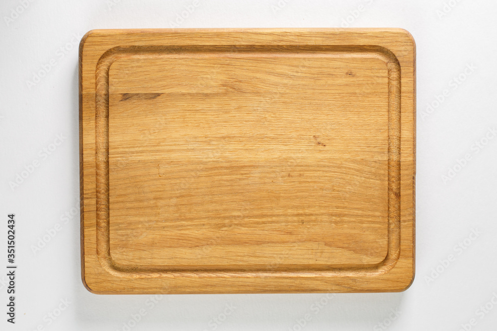 Brown board for slicing food on a white background Brown board for slicing food on a white background