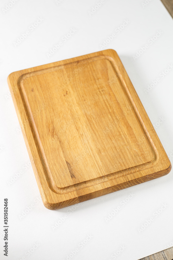 Brown board for slicing food on a white background Brown board for slicing food on a white background