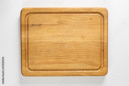Brown board for slicing food on a white background
