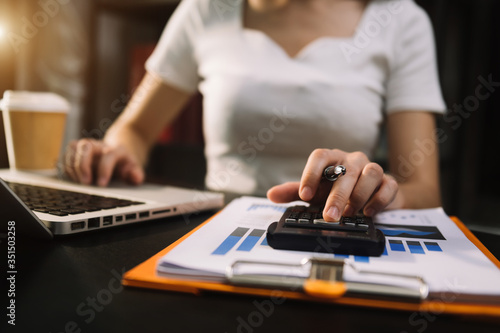 Hand man doing finances and on desk about cost at office.