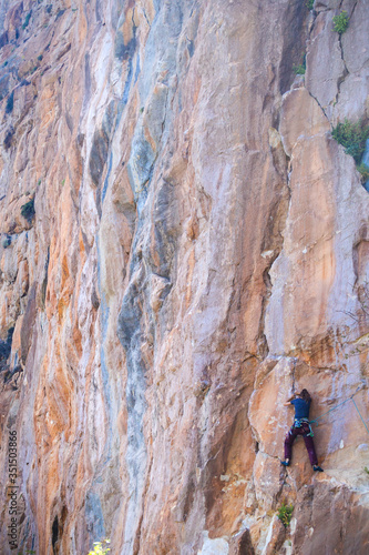 A strong girl climbs a rock, Rock climbing in Turkey.