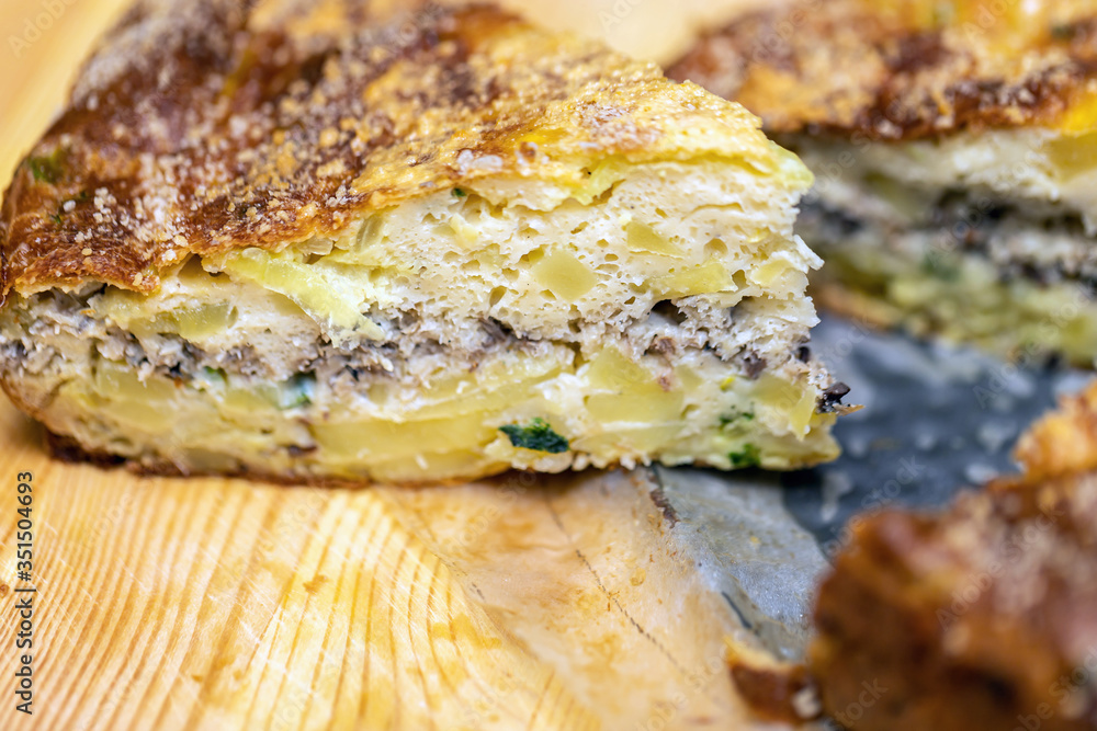 Homemade yeast-free cake on kefir with a filling of canned fish and potatoes, close-up. Homemade yeast-free cake on kefir with a filling of canned fish and potatoes, close-up.