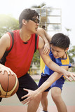 Men playing basketball together