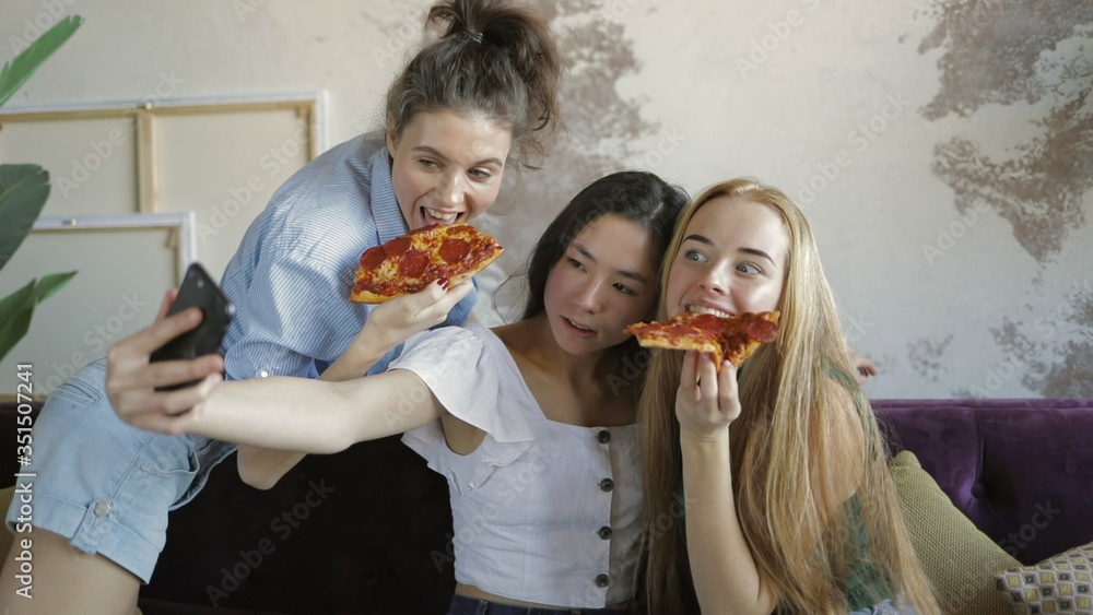Happy multiethnic friends eating pizza