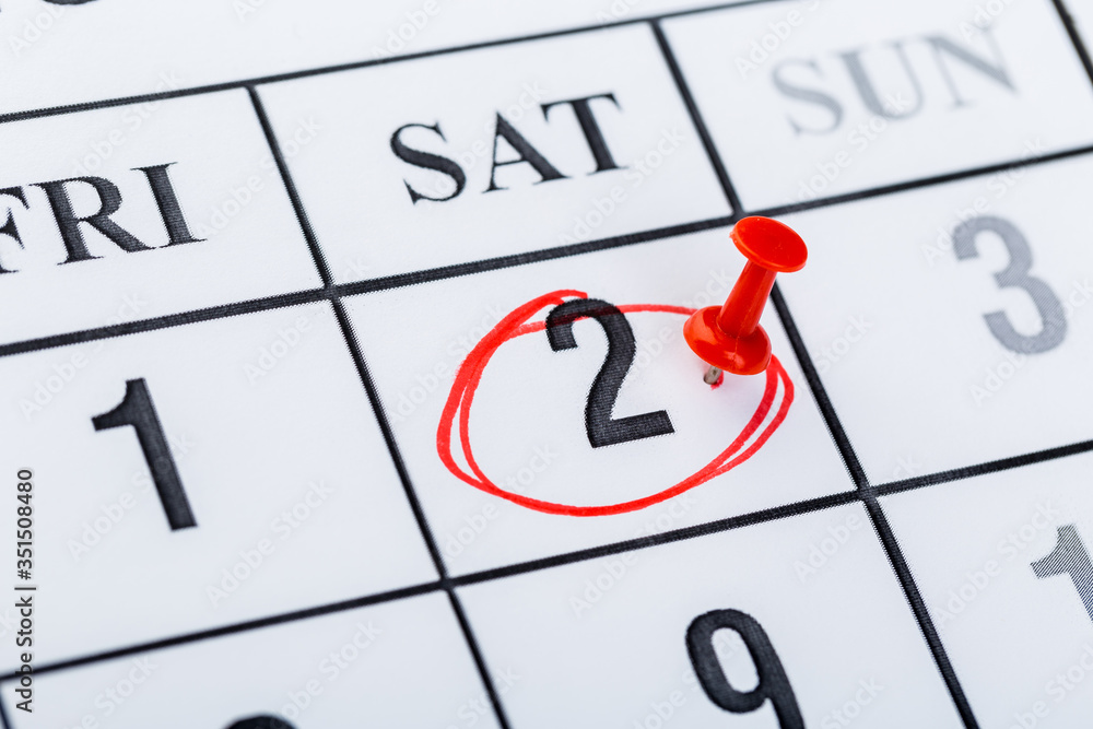 2020 calendar page marked with an important date in red pin. timeline, time, concept, idea, management 2020 calendar page marked with an important date in red pin. timeline, time, concept, idea, management