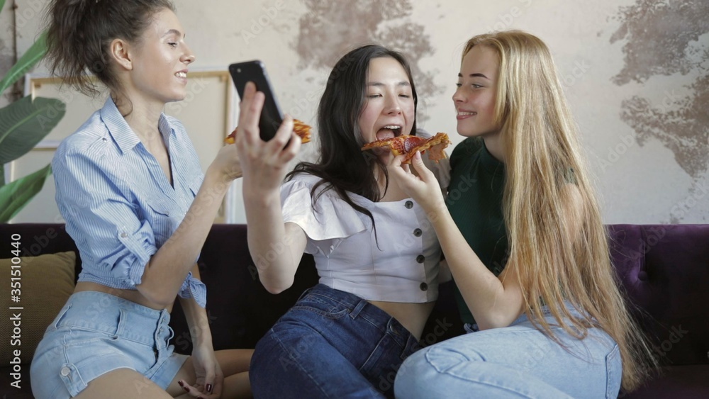 Happy multiethnic friends eating pizza Happy multiethnic friends eating pizza