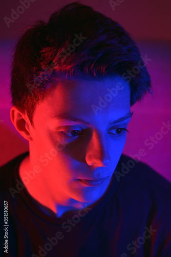 Young man Under Coloured Gel Lights