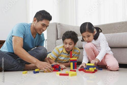 Cheerful father playing with his children