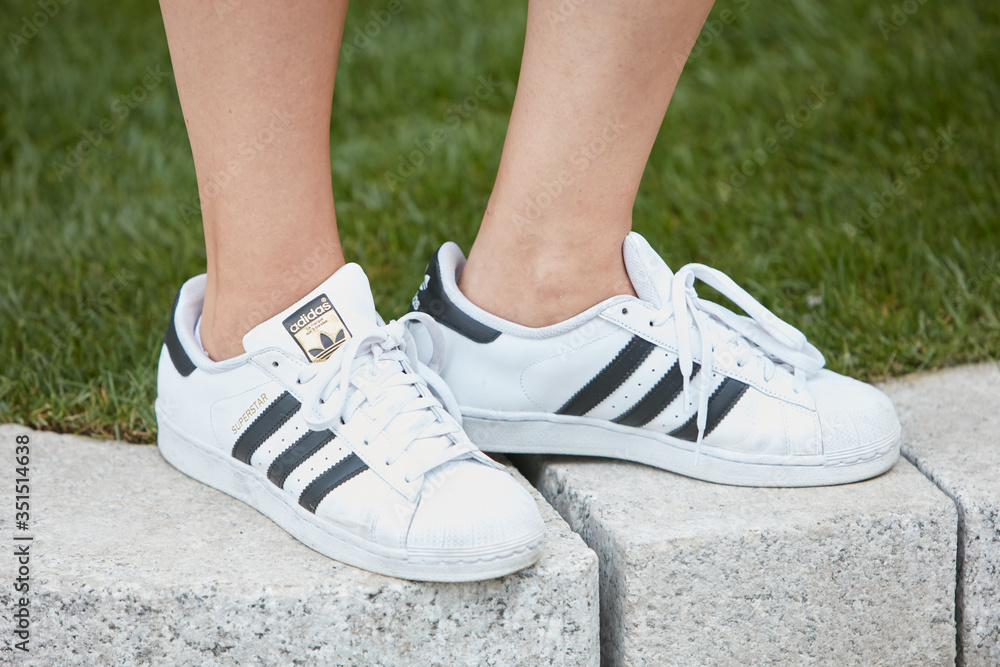 Woman with white Adidas superstar sneakers on September 23, 2016 in Milan,  Italy Stock Photo | Adobe Stock