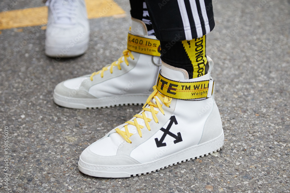 Foto Stock Man with Off White sneakers with yellow belt on January 15, 2018  in Milan, Italy | Adobe Stock