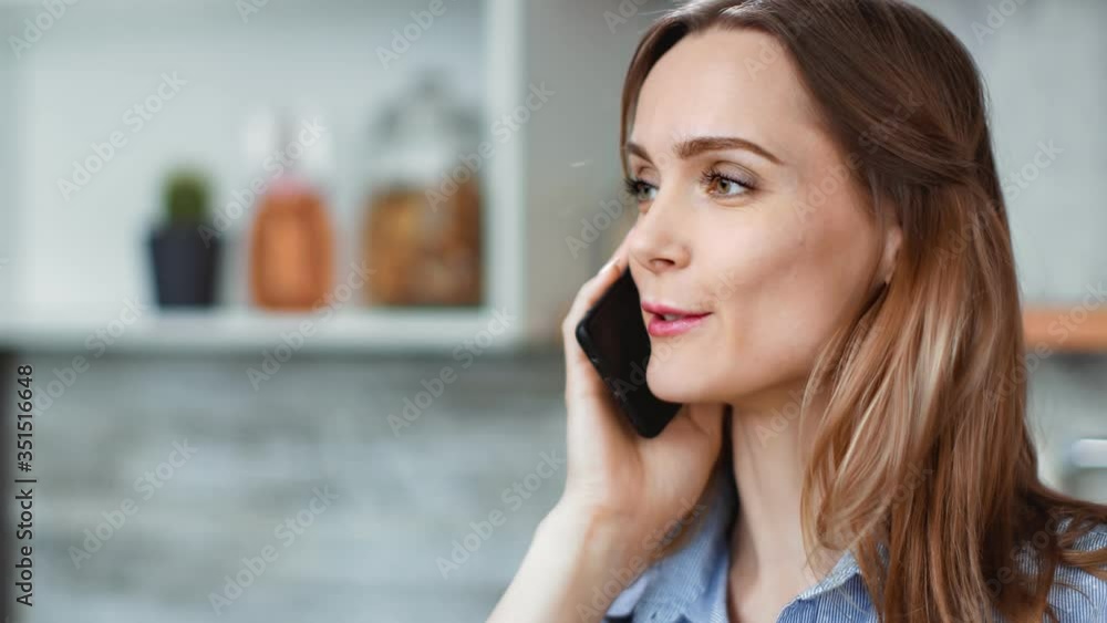 Young woman talking using smartphone having positive emotion. Shot on RED Raven 4k Cinema Camera Young woman talking using smartphone having positive emotion. Shot on RED Raven 4k Cinema Camera