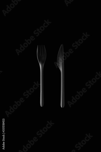 black fork and black knife on black background