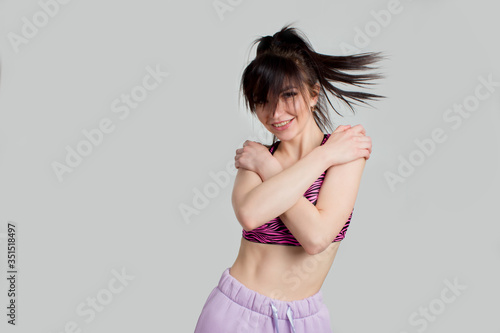 Sports fitness young woman has a slender figure. Concept of training and motivation, healthy lifestyle, isolate on a white background