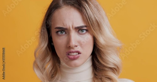 Disgusted blonde woman feeling aversion, frowning face