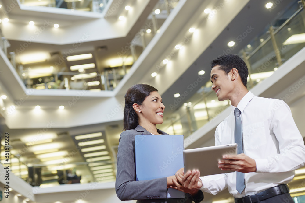Business partners discussing by using tablet Business partners discussing by using tablet